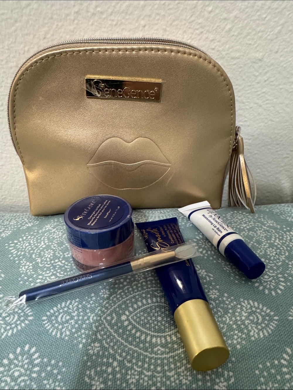 SeneGence Gold Makeup Pouch with lip mask, applicator, lip polish, and lip balm